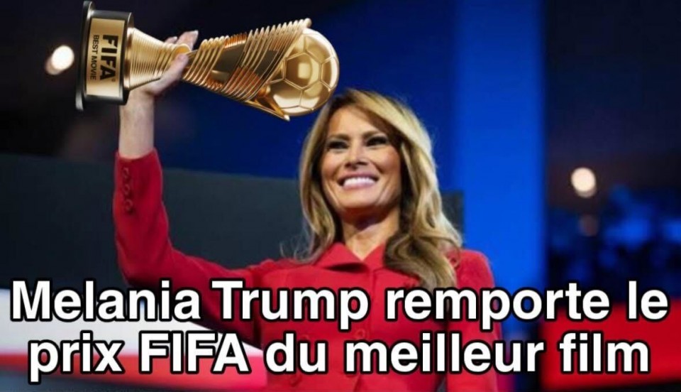 Melania Trump tient haut dans les airs le trophée de la compétition de soccer FIFA. Elle a un gros sourire. On peut lire sous l'image: Melania Trump remporte le prix FIFA du meilleur film. 